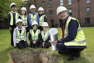 (Photo shoot 0616-017). Pupils from St James and Rosehill Federation School in Derby plant a time capsule at the Compendium Castleward development in the City Centre. Pictured with Compendium Project Manager Ian Woodland (red tie)