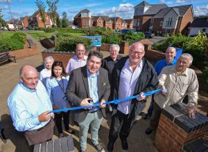 Stoke on Trent South MP Rob Flello cuts the ribbon to officially open the Weston Heights development, accompanied by, from left, Lovell Midlands regional director Steve Davis, Compendium Living project coordinator Wendy Lister, Riverside operations manager Cilla Aram, Stoke City councillor Ross Irving, Axis Design Architects director Mike Menzies, Compendium Living managing director Dave Bullock, Stoke City Council regeneration programme manager Phil Brundrett and Coalville Residents Association chairman Ernie Clarke.