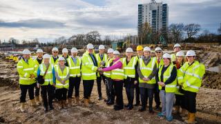 Group attending turf-cutting at Ings