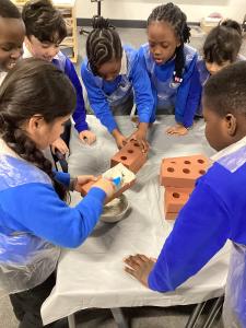Year 2 pupils laying foam bricks