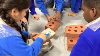 Year 2 pupils laying foam bricks